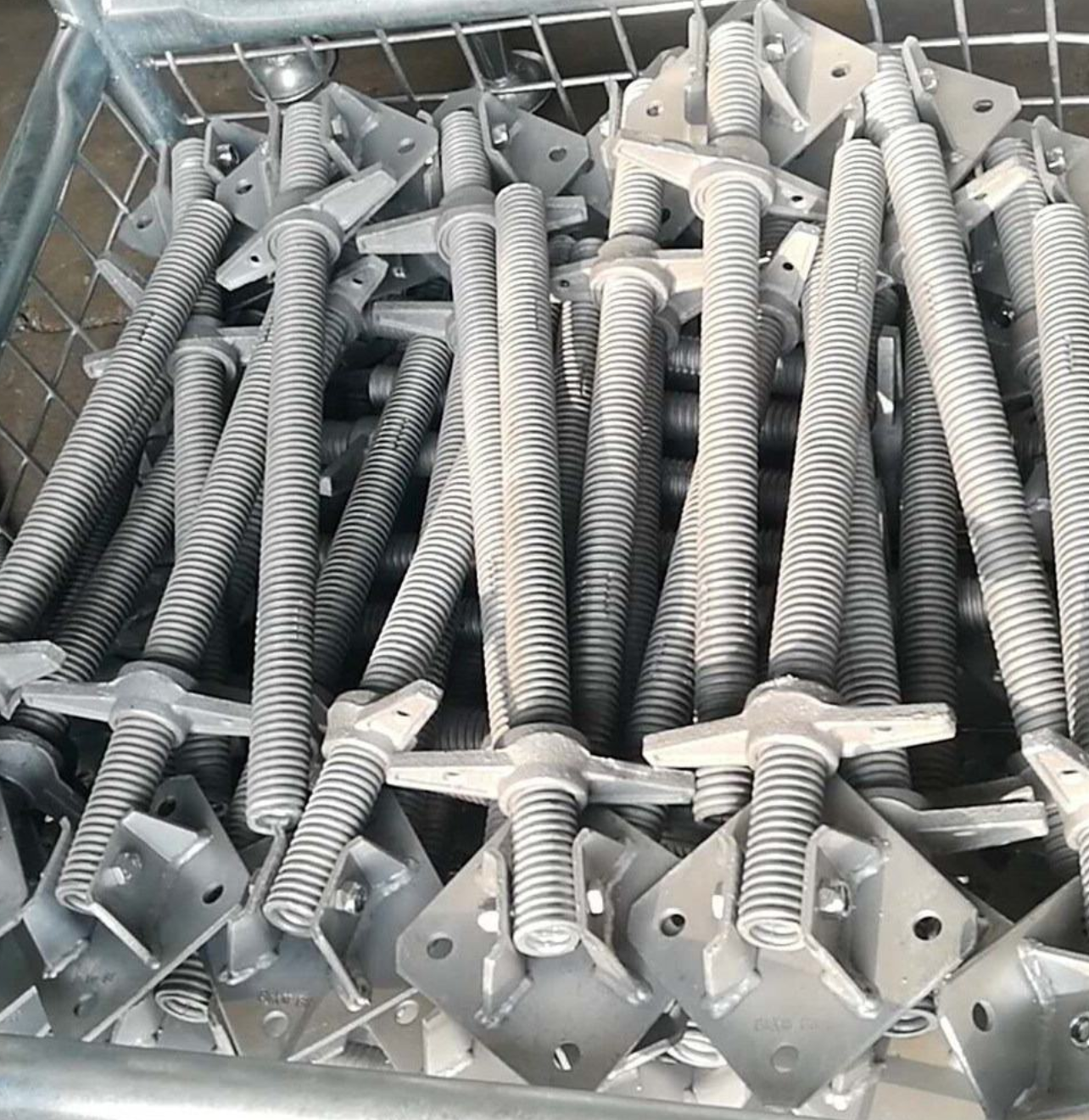Bulk screw jack base plates in storage